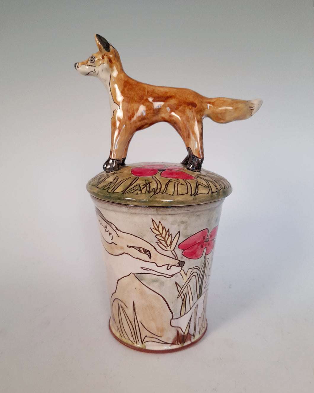 Fox store jar Earthenware decorated with  drawings of fox and little fox sculpture.